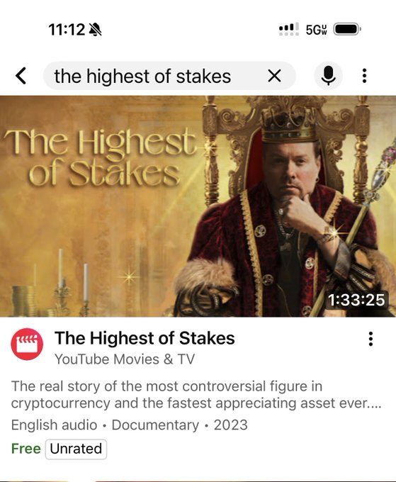 A YouTube search result for 'the highest of stakes' showing a documentary about 'The real story of the most controversial figure in cryptocurrency and the fastest appreciating asset ever...' featuring a man dressed as a king.