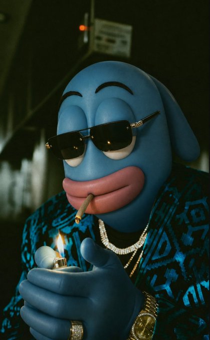 A surreal 3D-rendered blue fish-like character wearing sunglasses and a patterned jacket lights a cigar, adorned with gold jewelry including rings and a watch.
