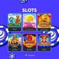 A screenshot of a slot machine game interface with various colorful slot icons on a blue background and a 'SLOTS' header.