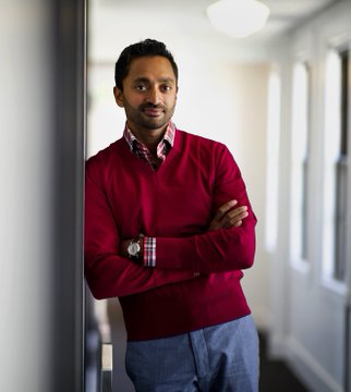 A man in a red sweater stands confidently with arms crossed in a brightly lit hallway. The image pairs with a post warning that capital is shifting from Bitcoin to AI, equities, and prediction markets, suggesting AI now offers better returns than BTC mining.