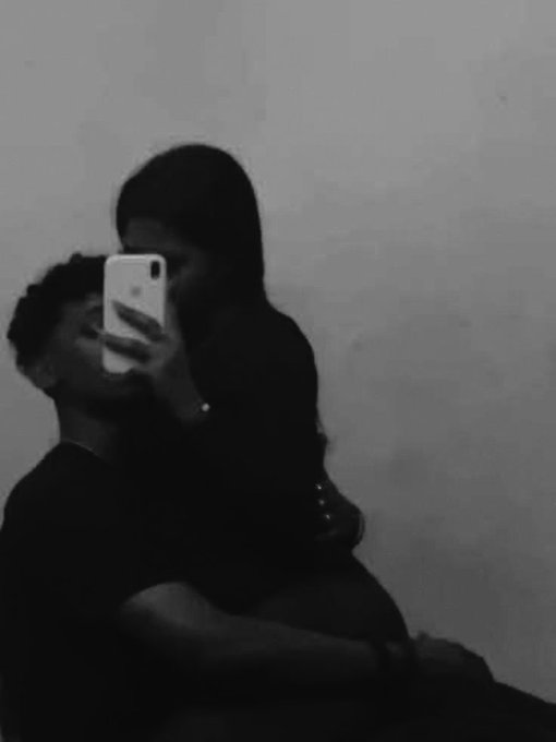 A person takes a mirror selfie with their phone in a dimly lit, black-and-white photo, while another individual embraces them from behind, evoking an intimate, end-of-night "gn" (goodnight) vibe that matches the casual sign-off in the caption.