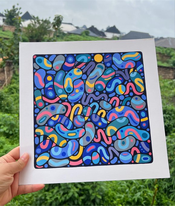 A hand holds up a vibrant abstract artwork titled "Odyssey" featuring a colorful array of squiggly shapes in blues, pinks, yellows, and grays against a black background, with the caption indicating it has 20 editions available at 0.017 ETH. The natural outdoor setting behind the print contrasts nicely with the bold, playful design of the digital art piece being displayed.