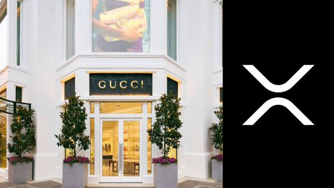 The image shows the exterior of a Gucci boutique featuring its signature gold lettering on the storefront entrance, paired with the XRP cryptocurrency logo on a black background—visually representing the luxury fashion brand's new acceptance of XRP payments at select U.S. locations.