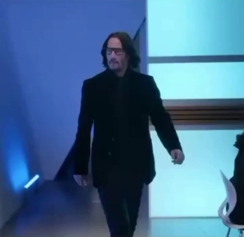 The image features a man wearing glasses, walking down a hallway or staircase while carrying a backpack. The caption of the image reads "get rich plan: buy Normies with dipping ETH", which suggests that the man might be involved in an online business related to Normies and is promoting the idea of investing in them using ethically-sourced ether.