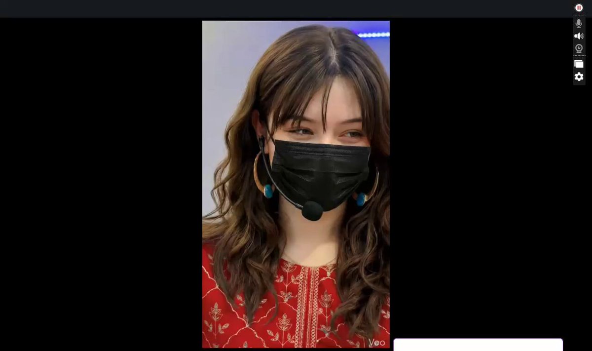 The image features a woman wearing a black face mask, which has been photoshopped with her face replaced by an image of herself. The background of the photo shows a computer screen displaying a website called "Focus on What Is". This suggests that the image is likely part of a promotional campaign or advertisement for a product or service related to the focus on what is in the image, possibly a strategy game or a virtual reality experience.