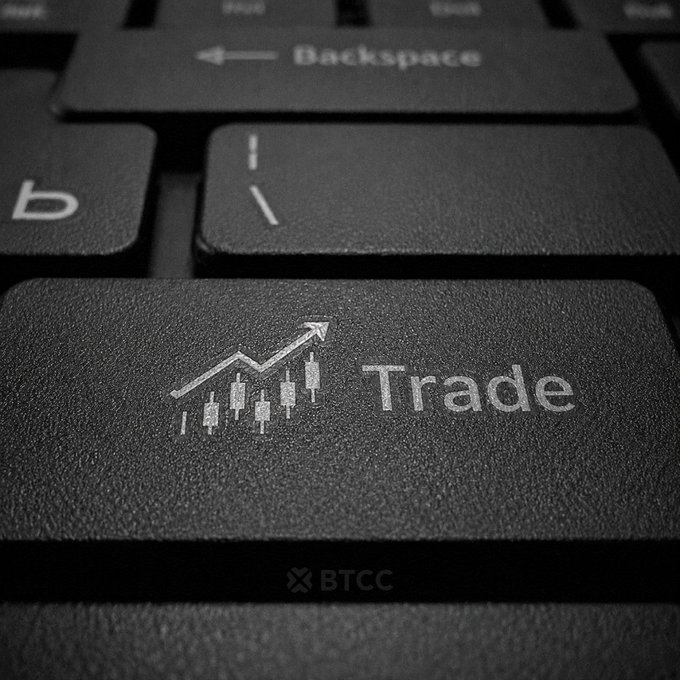 Close-up of a black computer keyboard featuring a prominent "Trade" key with a candlestick chart icon, alongside standard Backspace and slash keys, branded with the BTCC logo.