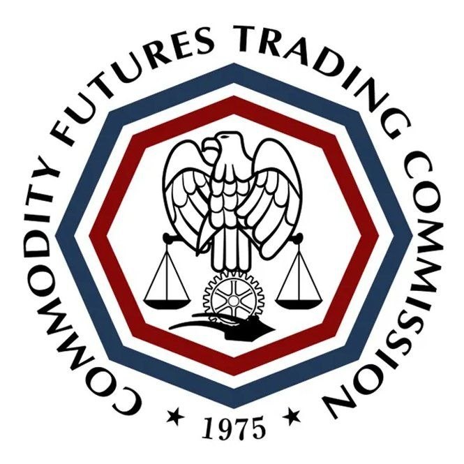 The image shows the official seal of the Commodity Futures Trading Commission (CFTC), featuring an eagle, scales of justice, and a gear design within a red and blue octagonal border, with "1975" inscribed at the bottom.

This seal represents the regulatory body mentioned in the post, whose Chairman has called for U.S. markets to prepare for mass tokenization and round-the-clock blockchain trading.