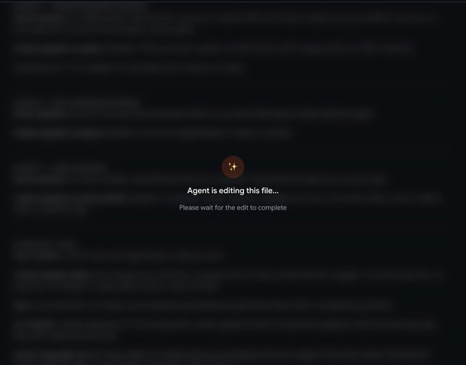 A dark screen displaying 'Agent is editing this file... Please wait for the edit to complete' with a sparkle icon.