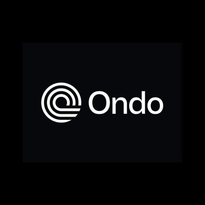 The image features a logo for an organization called "Ondo" written in white against a black background. The logo consists of a circle with a line through it, which is the company's name. The text "Ondo" is positioned at the center of the circle and is surrounded by a thin white line. Below the logo, there is some additional text that reads: "Despite everything that has happened, Ondo remains committed to executing its roadmap." This message emphasizes the organization's determination and focus on their goals despite any challenges they may face.