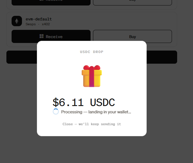 A pop-up on a crypto wallet interface shows a "USDC DROP" of $6.11 USDC processing, featuring a gift box icon, with options to "Receive" and "Buy" visible on the evm-default Swaps account in the background.