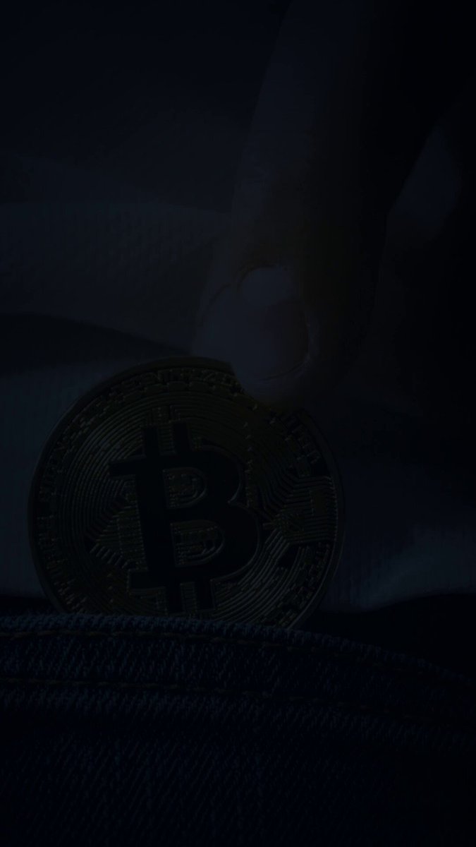 The image shows a hand holding a small gold coin with a Bitcoin symbol on it. The coin appears to be dirty or worn out, suggesting that it has been used for some time. The image also includes text that reads "Every Bitcoin that will ever exist is issued to a miner first. Everyone else is just trading the same coins around. Every Bitcoin in existence started as a miner'S reward. Over twenty million have been mined, each one issued to whoever mined the block. Right now only about four". The image seems to be related to the post discussing the history and origins of Bitcoins.