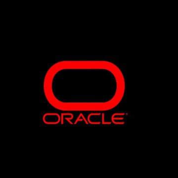 The image displays the Oracle logo, featuring the company's signature red oval symbol above the word "ORACLE" in red text on a black background. The logo visually represents the brand mentioned in the announcement about Oracle's investment in Texas wind projects to power its AI data centers with carbon-free electricity.