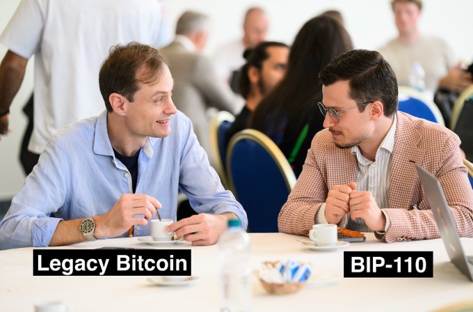 Two men sit at a conference table with coffee cups, labeled 'Legacy Bitcoin' and 'BIP-110', suggesting a discussion between the two Bitcoin factions.