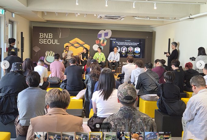 An audience seated at a "BNB SEOUL" event watching a panel discussion titled "The Invisible World from Financial Markets to Crypto and Beyond."
