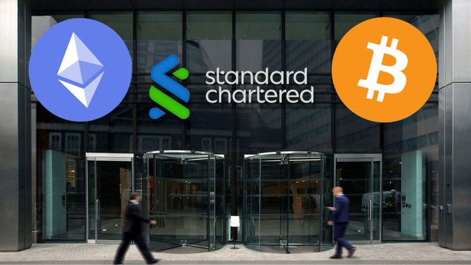 A person walks past a Standard Chartered bank entrance, with overlaid logos of Ethereum ($ETH) and Bitcoin ($BTC), illustrating the bank's new offering allowing UAE clients to trade the two cryptocurrencies directly through their bank accounts.