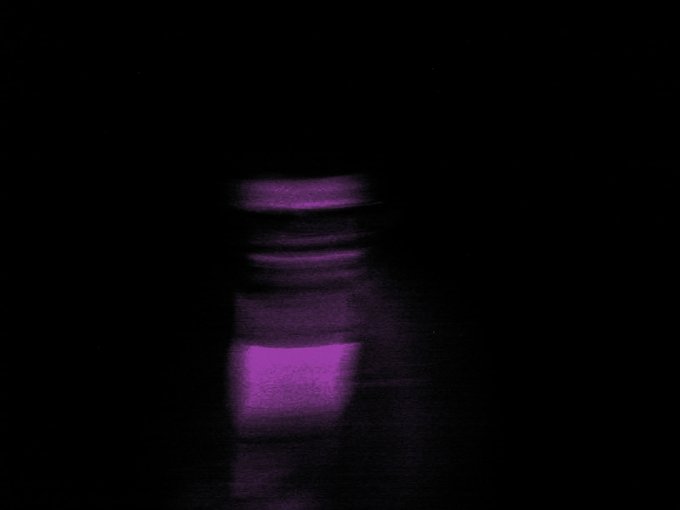 The image features a purple object, possibly a bottle or a vase, placed against a black background. The object appears blurry due to motion blur, suggesting that it was captured with a slow shutter speed. The caption of the image reads "tysm @macbethAI for curating one on my pieces from Lofi-Los Angeles in the latest @solarchi_ Curates' collection". This implies that the image is part of an online gallery showcasing artwork by a specific artist or designer, with the focus being on the purple object and its background.