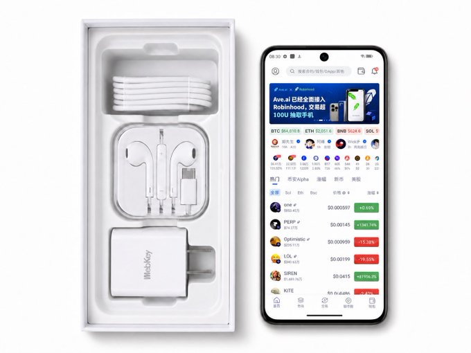 An unboxed 'BitbabKey' product package showing a charging cable, earphones, and a power adapter next to a smartphone displaying a crypto trading app with Bitcoin (BTC) at $94,818 and other tokens like ETH, BNB, and SOL.