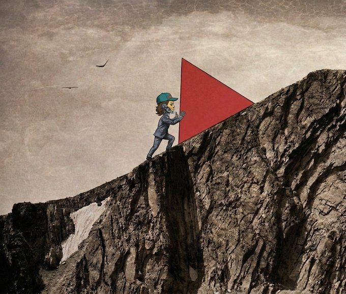 A surreal mixed-media style illustration depicts a figure in a blue suit and cap pushing a large red triangle up a steep, rocky cliff face against a cloudy sky with two birds in the distance.
