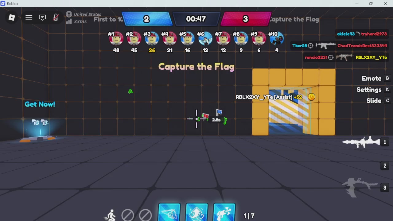 The image shows a computer screen displaying a video game scene with a group of people playing a game called " Capture the Flag". There are multiple players, each holding flags and engaged in various activities within the game. The player holding the flag closest to the camera is wearing a blue shirt. The game appears to be set in an open area or field, as indicated by the presence of a yellow building in the background.