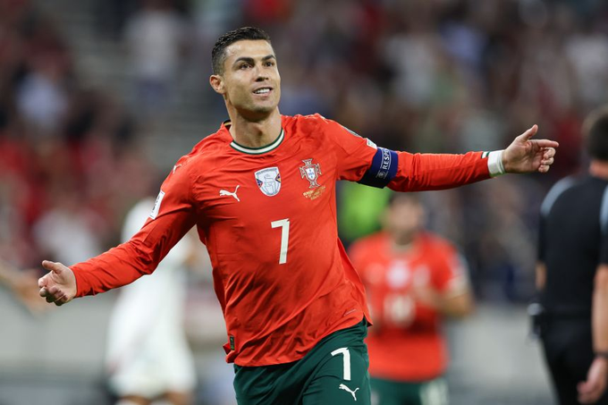 Cristiano Ronaldo wearing the Portugal jersey, with "7" on his shirt, celebrates on the field. He is shown in action, hinting at the possibility of him scoring a hat-trick.