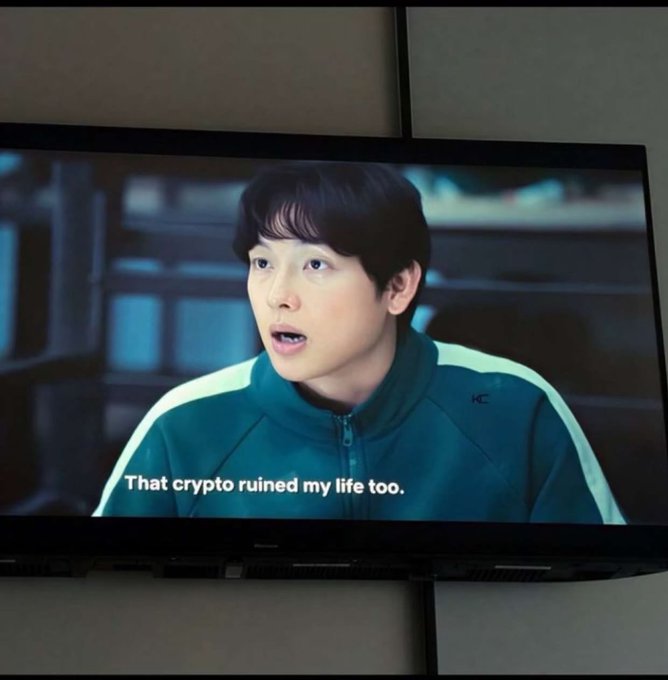 A TV screen shows a young man in a teal tracksuit with the subtitle "That crypto ruined my life too," humorously echoing the post's expression of frustration over Robinhood-related crypto losses.