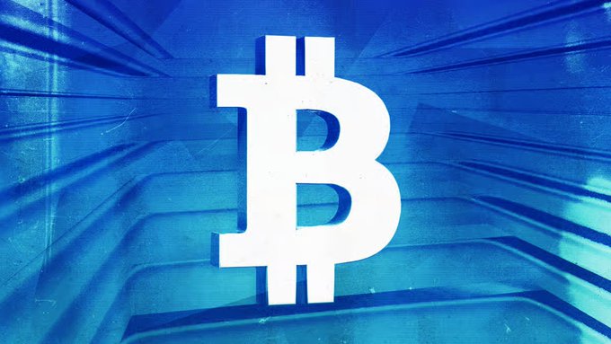 A stylized image of the Bitcoin symbol (₿) in white against a blue, radiant background.