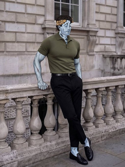 A digitally edited or surreal image shows a figure wearing an olive green polo shirt, black pants, and loafers, but with pale blue-grey skin and a golden laurel wreath, leaning against an ornate stone balustrade.