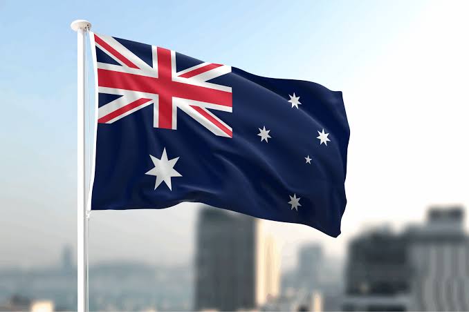 The Australian flag waves against a city skyline, visually anchoring the post's announcement about Australia's strict new September 30 deadline for unlicensed crypto firms to obtain financial services licenses or face heavy fines.

The Australian flag waves against a city skyline, visually reinforcing the post's message about Australia's intensified crackdown on unlicensed crypto firms ahead of the September 30 licensing deadline.