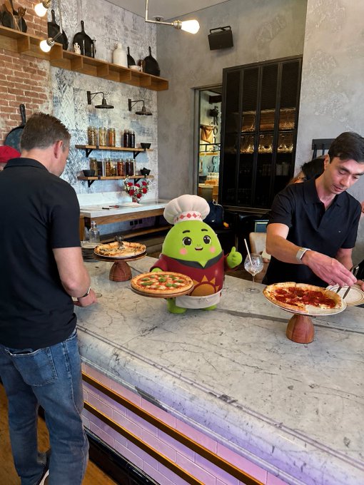 The image features a man wearing a chef's hat standing behind a counter with two pizzas displayed on plates. There are also three people present in the scene, one of whom appears to be an AI system or a robot designed for cooking tasks. The AI is positioned near the center of the image and seems to be interacting with the chef by holding up a pizza.

The post about AI changing how we live emphasizes the importance of understanding and optimizing our daily lives through technology integration, including aspects like sleep tracking and wellness management. In this context, the AI system in the image could potentially assist in managing tasks related to cooking or meal preparation, which can contribute to better overall health and well-being.