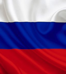 The image shows the flag of Russia with its distinctive white, blue, and red horizontal stripes flowing in the wind. This flag visually represents Russia, the country whose State Duma is set to vote on the landmark crypto bill that would legalize cryptocurrency for international trade and regulate it as property with strict retail investment limits.