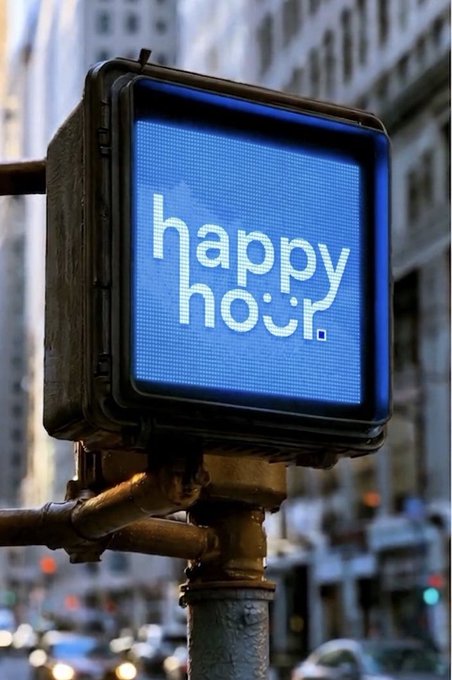 A street sign displays "happy hour." in white pixelated text on a blue LED screen, mounted on a metal pole against a backdrop of city buildings. The image serves as a visual metaphor for the Happy Hour Base mini app, symbolizing accessibility and visibility for users exploring the platform through their existing wallets.