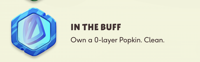 A game achievement icon showing a blue hexagonal gem with the text 'IN THE BUFF' and 'Own a 0-layer Popkin. Clean.'