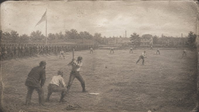 A sepia-toned historical photograph of a baseball game in progress, showing players on a field with an American flag and a row of soldiers standing in the background.