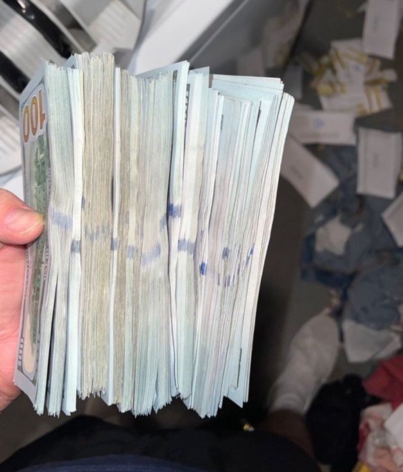 A hand holds a large stack of $100 bills, representing a significant financial windfall that many aspire to. The image visually depicts the "financial breakthrough" mentioned in the accompanying post.