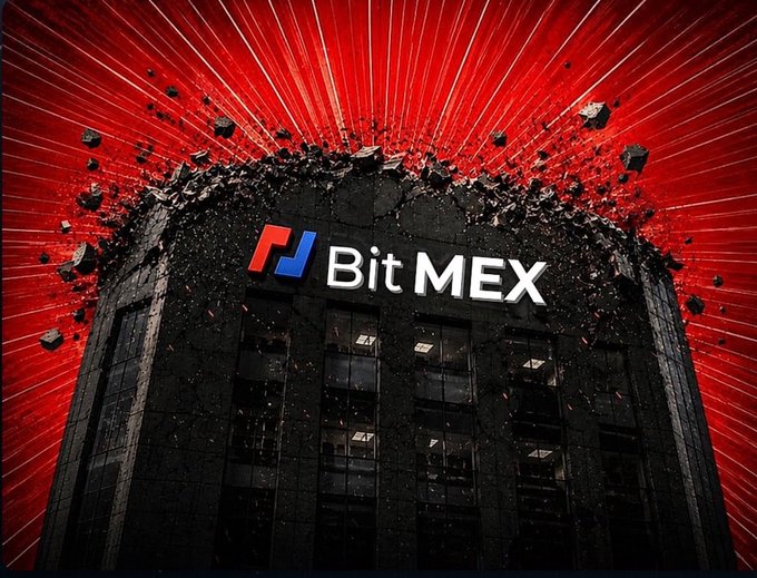 The image shows a dark building with the "BitMEX" logo prominently displayed, dramatically exploding apart at the top with debris scattering outward against a vibrant red background with radiating light streaks, symbolizing the exchange's sudden shutdown.

The explosive imagery powerfully visualizes BitMEX's abrupt closure after 11 years, representing the dramatic end of the pioneering crypto derivatives exchange that invented the perpetual swap contract.