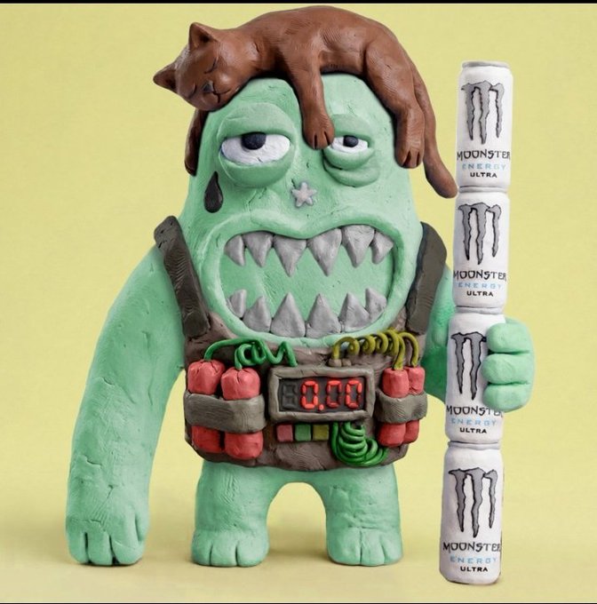 A green claymation monster with sharp teeth and a brown cat draped over its head holds a stack of four Monster Energy Ultra cans, featuring visible "Monster Energy Ultra" branding and a digital display reading "0.00" on its chest. The playful, chaotic sculpture ties into the post's hype for "just_t00ns," suggesting the group will rally to boost the token's value.