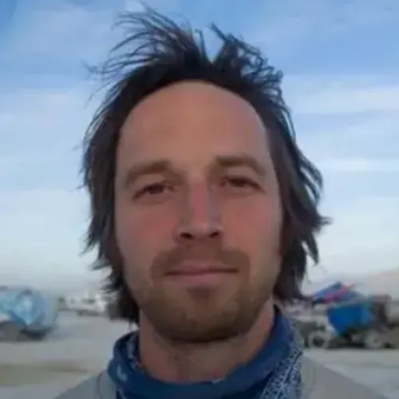 The image features a man with long hair wearing a bandana, standing outdoors against a blue sky. The caption of the image includes the hashtag #RIPPLEPAY, which might be related to an event or cause that took place on April Fool's Day in 2004. The post seems to be promoting awareness about the importance of mental health and self-care during challenging times.