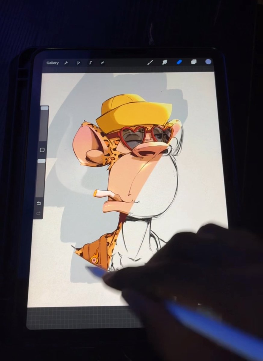 A digital tablet displays an in-progress illustration of a cartoon cheetah-like character wearing a yellow cap and heart-shaped sunglasses, with a hand holding a stylus.