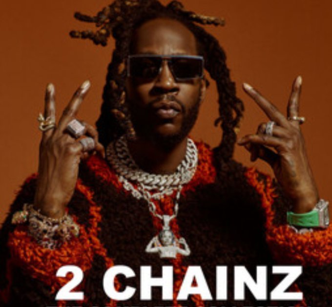 The image features a man with dreadlocks wearing sunglasses, multiple large chains, and a red and black sweater, flashing hand gestures against an orange background. The text "2 CHAINZ" appears at the bottom, identifying him as the rapper, though the post seems unrelated as it begins with "It's official! There are now..."