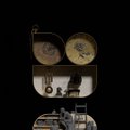 A vintage typewriter or sewing machine with two round metallic components displayed against a black background.
