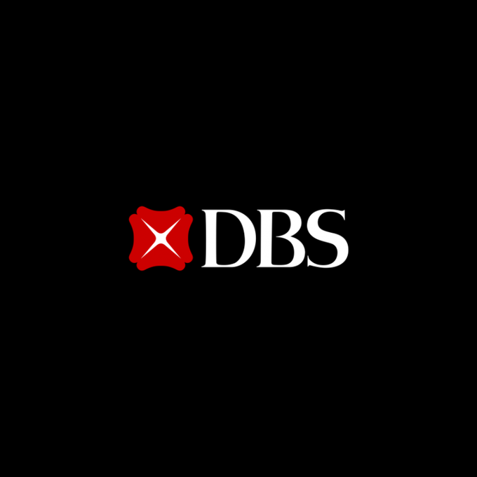 The image displays the DBS logo, featuring a red shield-like emblem with a white star next to the white letters "DBS" on a black background. This corresponds to the post announcing DBS's partnership with Citi to enable instant, 24/7 cross-border USD payments using tokenized deposits on Swift's blockchain-based ledger.