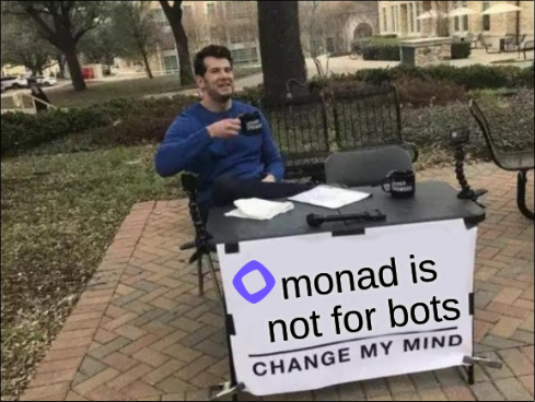 A man sits at an outdoor 'Change My Mind' table holding a mug, with a sign reading 'monad is not for bots'.