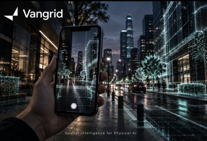 Advertisement for 'Vangrid' showing a hand holding a smartphone that uses augmented reality to display wireframe data over a nighttime city street, with the tagline 'Spatial intelligence for Physical AI'.