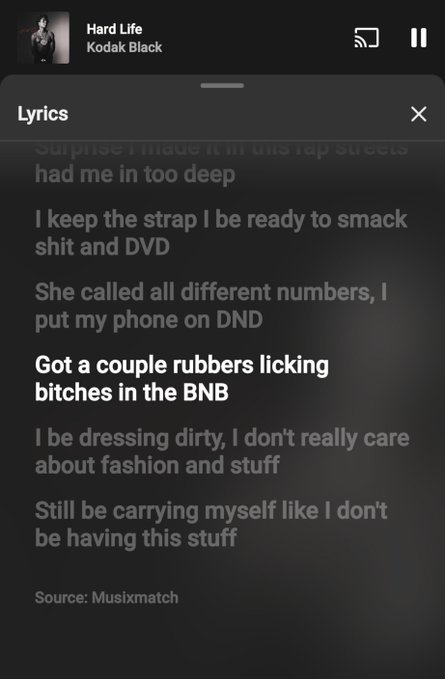 A Spotify lyrics screen for "Hard Life" by Kodak Black, with the line "Got a couple rubbers licking bitches in the BNB" highlighted in white against the dark background.