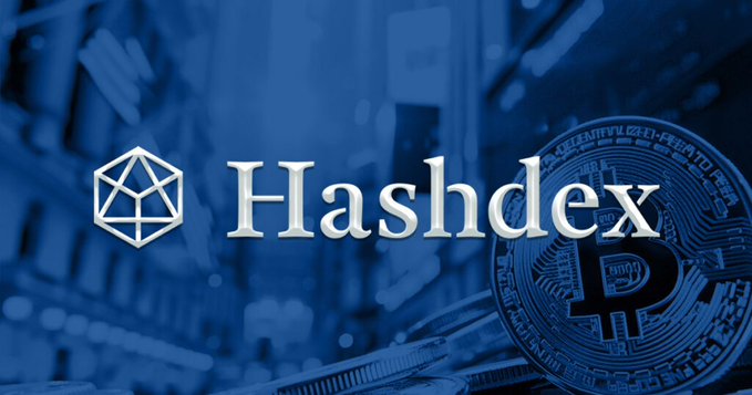 The image features the Hashdex logo prominently displayed alongside a stylized Bitcoin coin, set against a blue-toned background of cryptocurrency mining hardware. This visual accompanies news of Hashdex closing the first spot Bitcoin ETF in the US, with the Bitcoin imagery reinforcing the article's focus on cryptocurrency investment products.