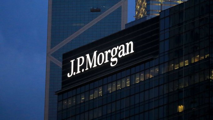 The J.P. Morgan logo is prominently displayed on a glass skyscraper, representing the major financial institution whose analysts are weighing in on Bitcoin's potential to gain relative support over gold amid shifting ETF hedging demand.
