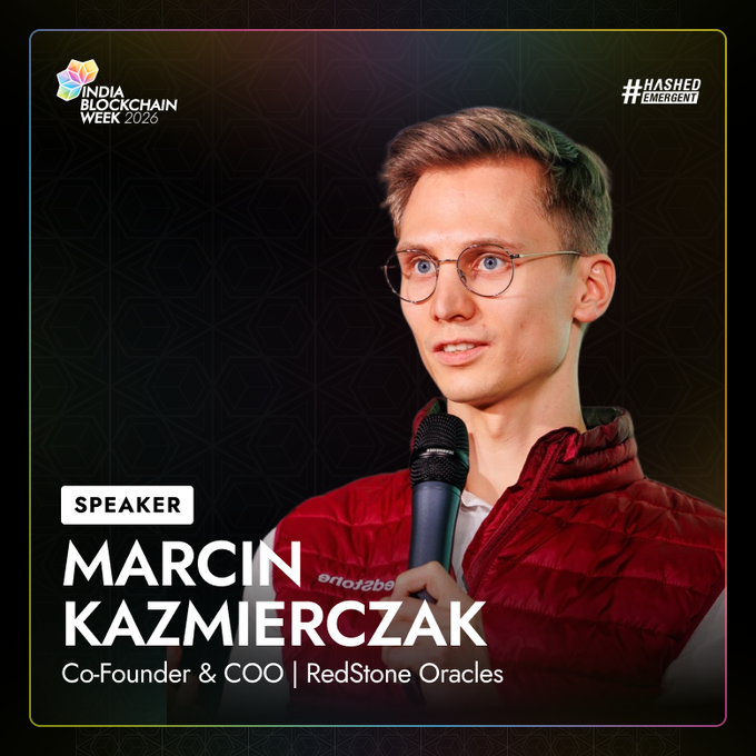 A speaker announcement graphic for India Blockchain Week 2026 featuring Marcin Kazmierczak, Co-Founder & COO of RedStone Oracles, shown speaking into a microphone wearing glasses and a red vest, with his name and title displayed prominently alongside the IBW2026 and #HashedEmergent logos.