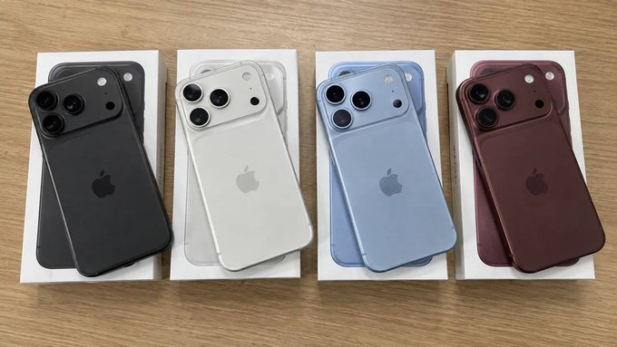 Four iPhones are displayed on top of their boxes in different colors: black, white, light blue, and dark red/burgundy.
