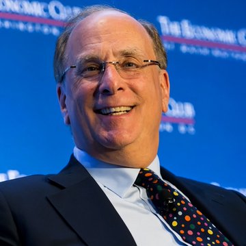 A smiling man in a dark suit and polka-dot tie is photographed in front of a blue backdrop bearing "The Economic Club" logo, appearing to be Larry Fink, CEO of BlackRock. His presence connects to the post's message about BlackRock clients purchasing $2.2 billion in Bitcoin, highlighting the institutional money flowing into BTC.