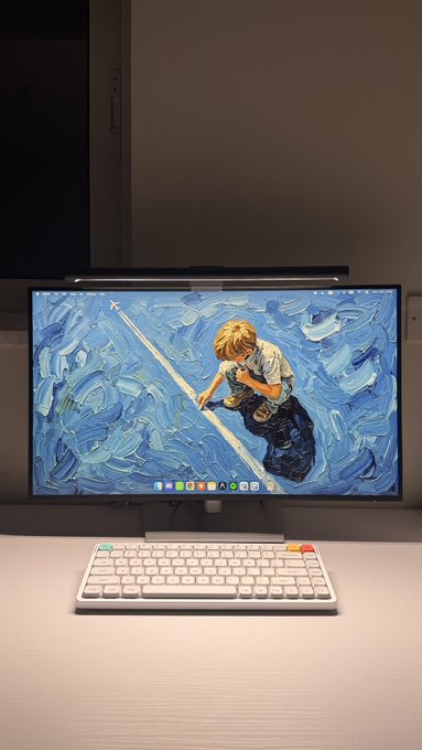 A computer monitor displays a Van Gogh 'Starry Night'-style impasto painting of a boy walking on a tightrope, paired with a mechanical keyboard on a desk.